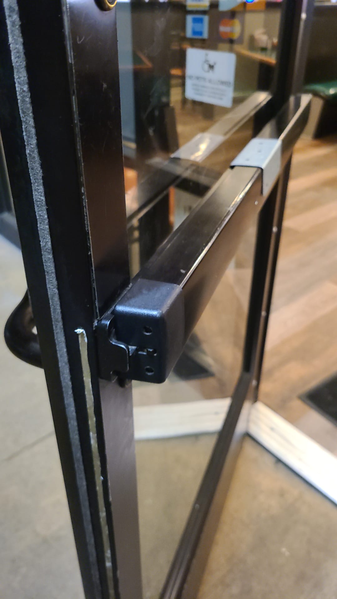 Panic bar exit device on a commercial glass door